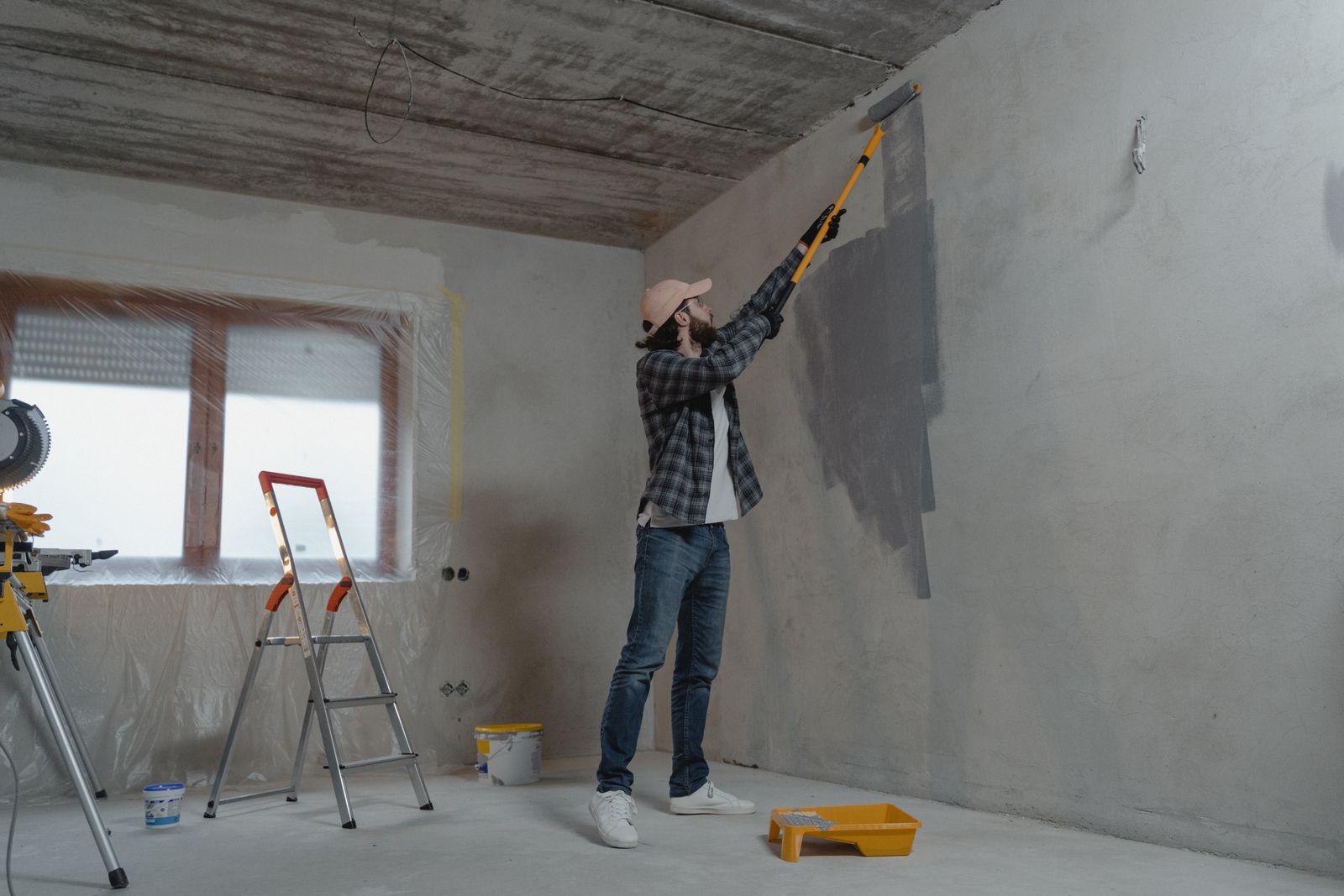 Painter rolling a wall during an interior paint job